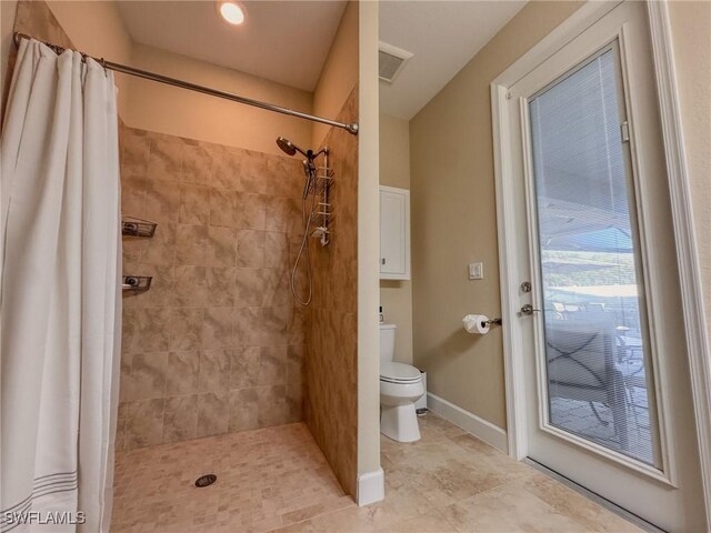 bathroom with toilet and curtained shower