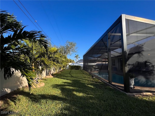 view of yard with glass enclosure