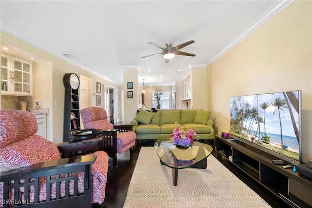 living room featuring ceiling fan, wood-type flooring, and crown molding