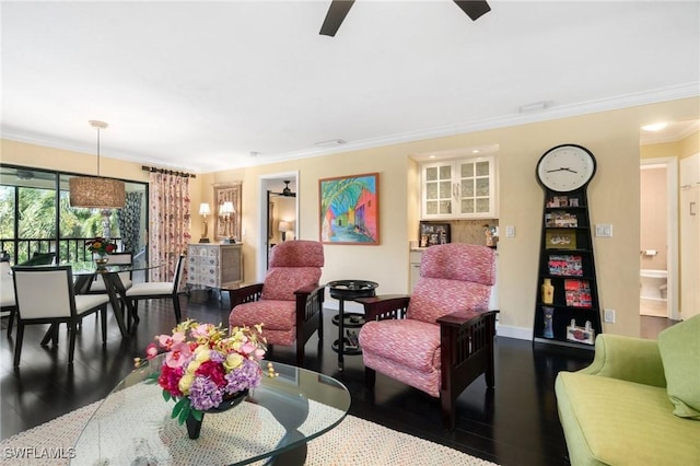 living room featuring ceiling fan, dark wood-type flooring, and ornamental molding