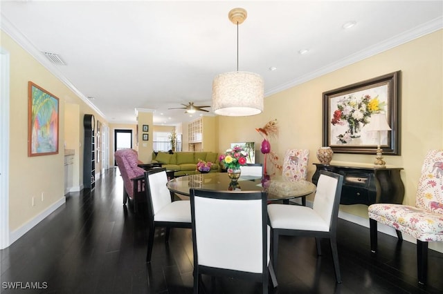 dining area with ceiling fan, dark hardwood / wood-style flooring, and ornamental molding