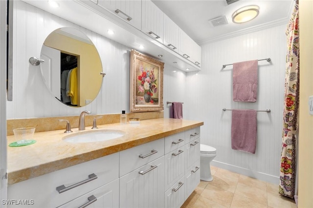 bathroom with tile patterned flooring, vanity, toilet, and ornamental molding