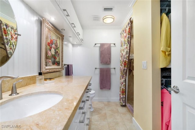 bathroom featuring vanity, crown molding, tile patterned flooring, toilet, and curtained shower