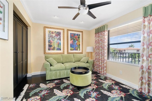 living room with ceiling fan, dark hardwood / wood-style flooring, and ornamental molding