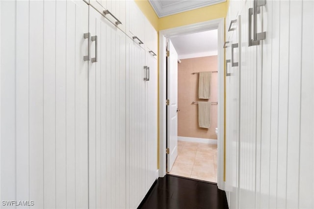 hall featuring tile patterned floors and crown molding