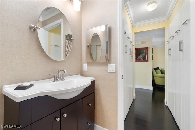 bathroom featuring vanity, hardwood / wood-style flooring, and ornamental molding