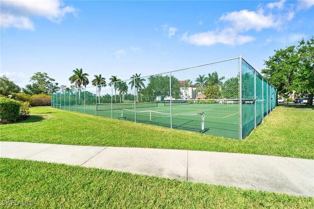 view of sport court with a yard