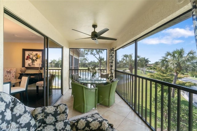 sunroom featuring ceiling fan and a healthy amount of sunlight