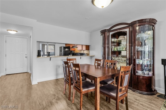 dining area with light wood-type flooring