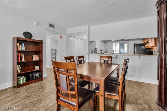 dining space featuring light hardwood / wood-style floors