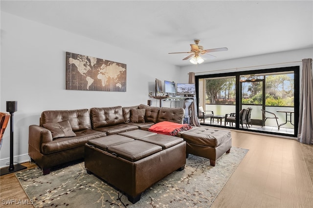 living room with hardwood / wood-style floors and ceiling fan