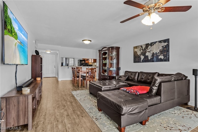 living room featuring hardwood / wood-style floors and ceiling fan