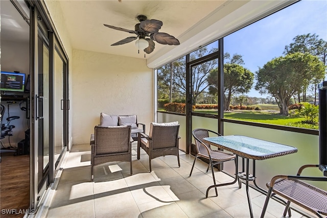 sunroom featuring ceiling fan