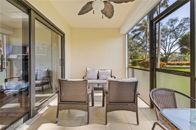 sunroom / solarium featuring ceiling fan