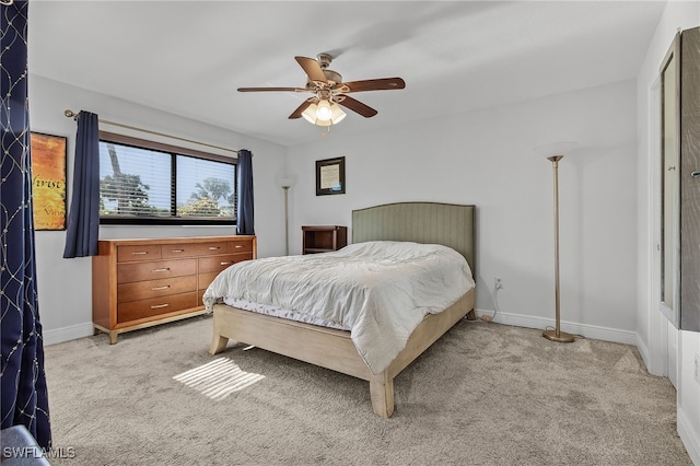 bedroom with ceiling fan and light carpet