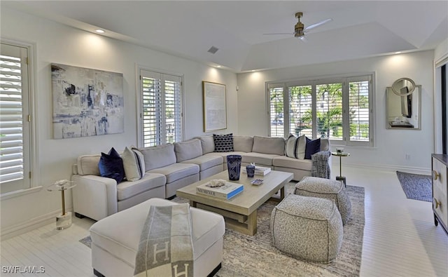 living room with ceiling fan and lofted ceiling