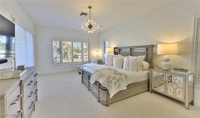 carpeted bedroom featuring an inviting chandelier