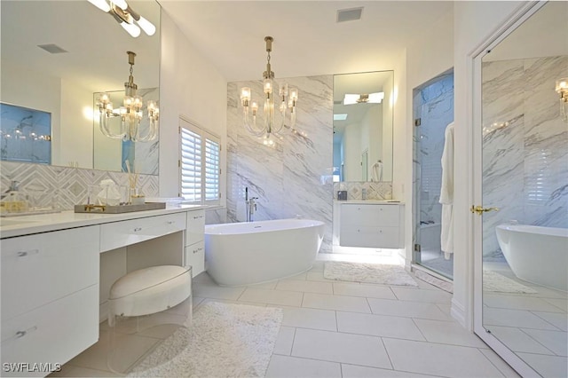 bathroom with vanity, separate shower and tub, a notable chandelier, and tile patterned flooring