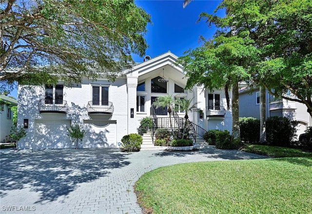 view of front of house with a front yard and a garage