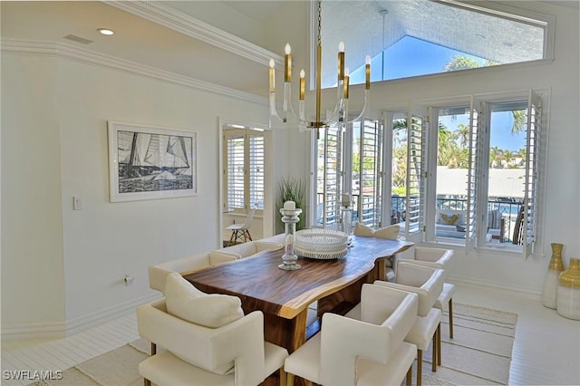 dining space featuring a wealth of natural light, lofted ceiling, and a chandelier