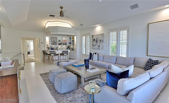 living room featuring ceiling fan and vaulted ceiling