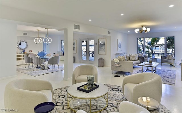 living room with an inviting chandelier and french doors