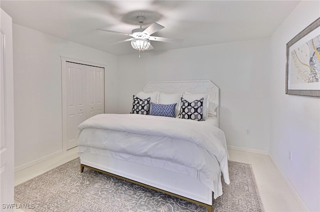 bedroom with ceiling fan and a closet