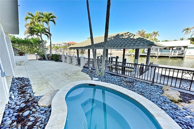 view of swimming pool with a water view and an in ground hot tub