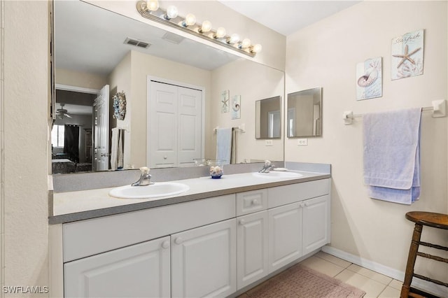 bathroom with tile patterned flooring, vanity, and ceiling fan