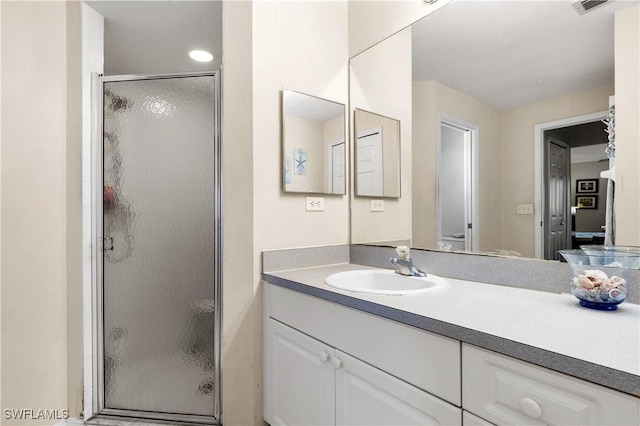 bathroom featuring vanity and a shower with shower door