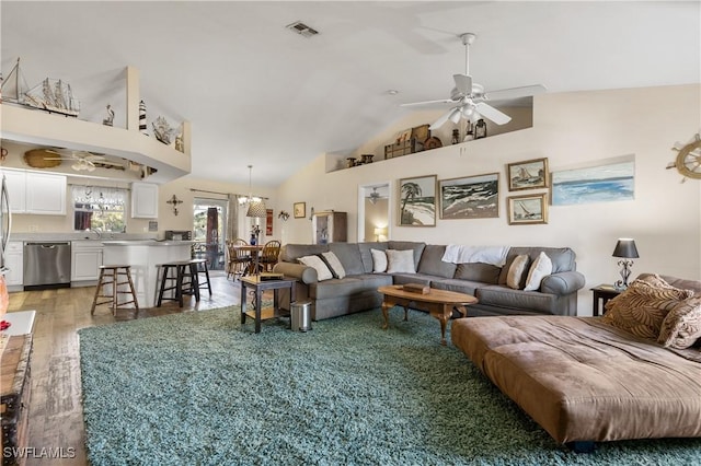 living room featuring lofted ceiling, ceiling fan, and wood-type flooring