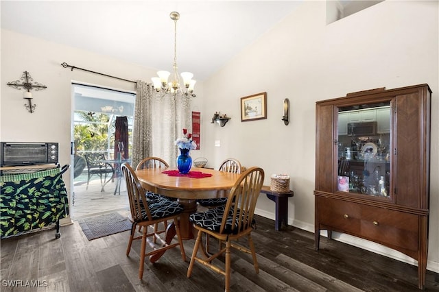 dining room with dark hardwood / wood-style flooring, lofted ceiling, and an inviting chandelier