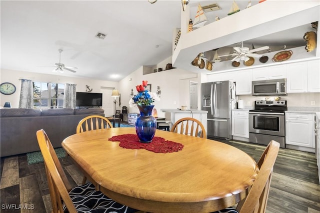 dining space featuring dark hardwood / wood-style floors and high vaulted ceiling