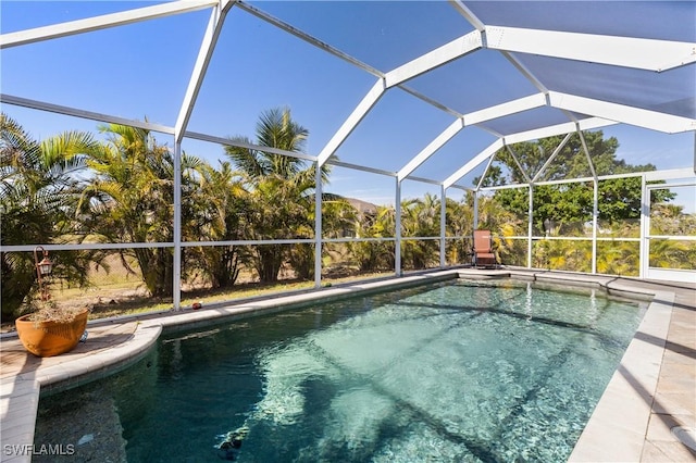 view of swimming pool with glass enclosure