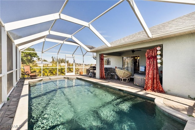 view of pool with a patio, ceiling fan, and a lanai