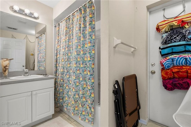 bathroom featuring tile patterned floors, vanity, and curtained shower