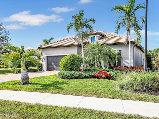 view of front of property with a garage and a front lawn