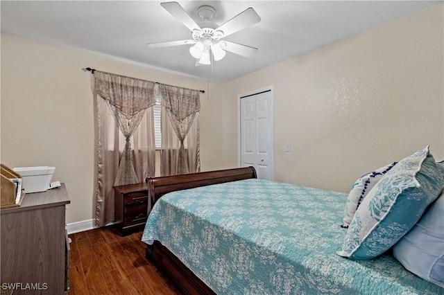 bedroom featuring ceiling fan, a closet, and dark wood-type flooring