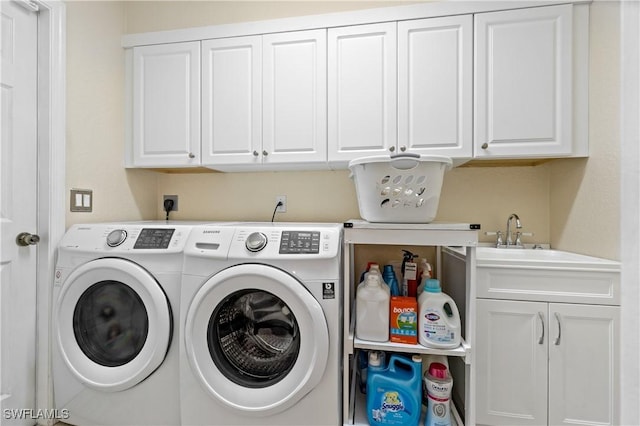 laundry area with cabinets and washing machine and dryer