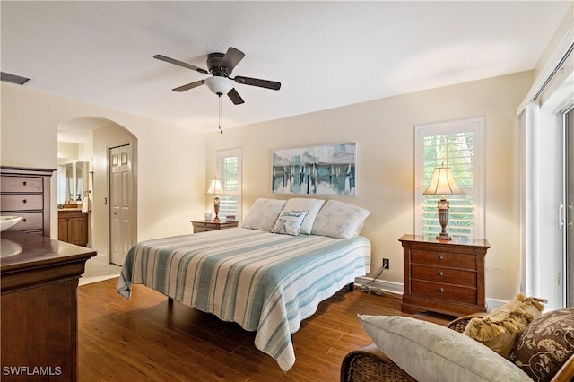 bedroom featuring ensuite bath, ceiling fan, and dark hardwood / wood-style flooring