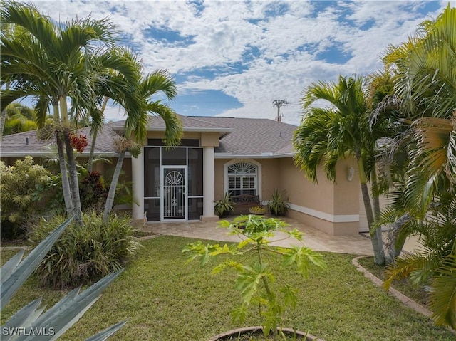 doorway to property featuring a yard