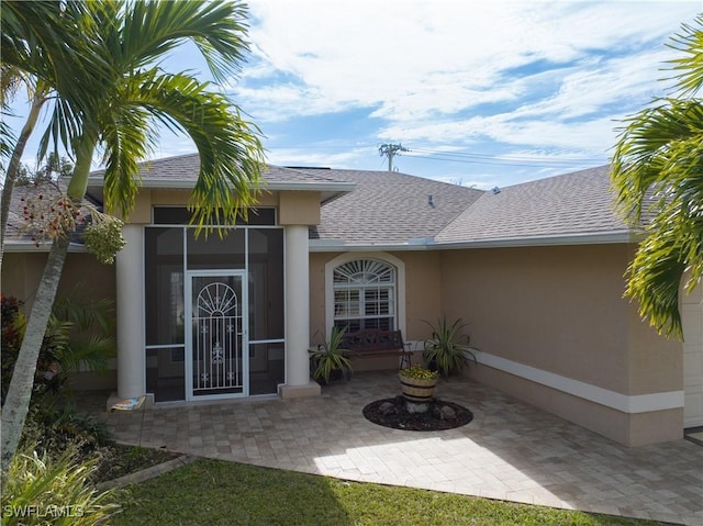 view of exterior entry featuring a patio