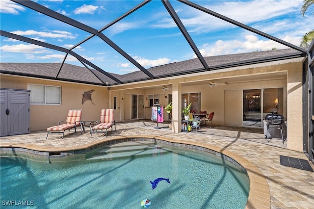 view of pool featuring a lanai, grilling area, ceiling fan, and a patio area