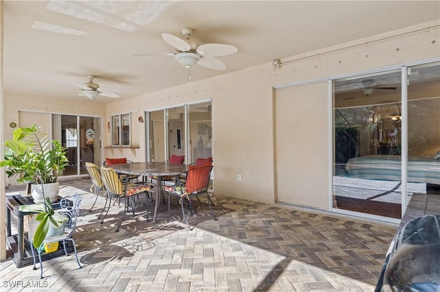 sunroom featuring ceiling fan