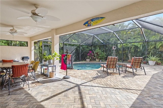 view of patio featuring ceiling fan and a lanai