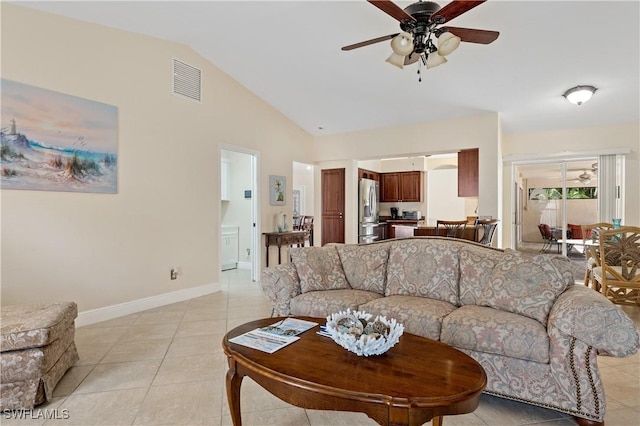 living room featuring ceiling fan, lofted ceiling, and light tile patterned floors