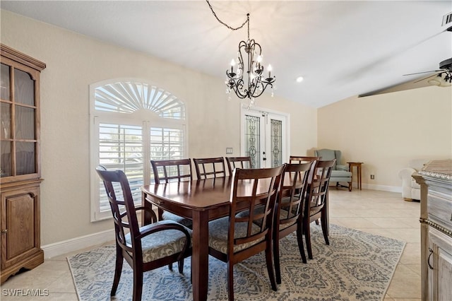 dining area with lofted ceiling, french doors, light tile patterned floors, and ceiling fan with notable chandelier