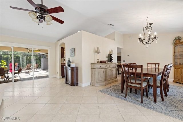 dining area featuring vaulted ceiling, light tile patterned floors, and ceiling fan with notable chandelier