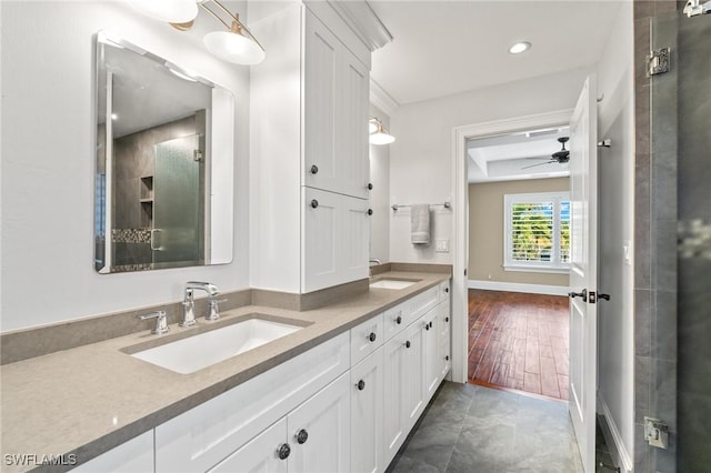 bathroom featuring tile patterned floors, vanity, ceiling fan, and walk in shower