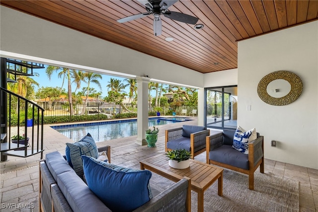 view of patio / terrace featuring a fenced in pool, an outdoor living space, and ceiling fan